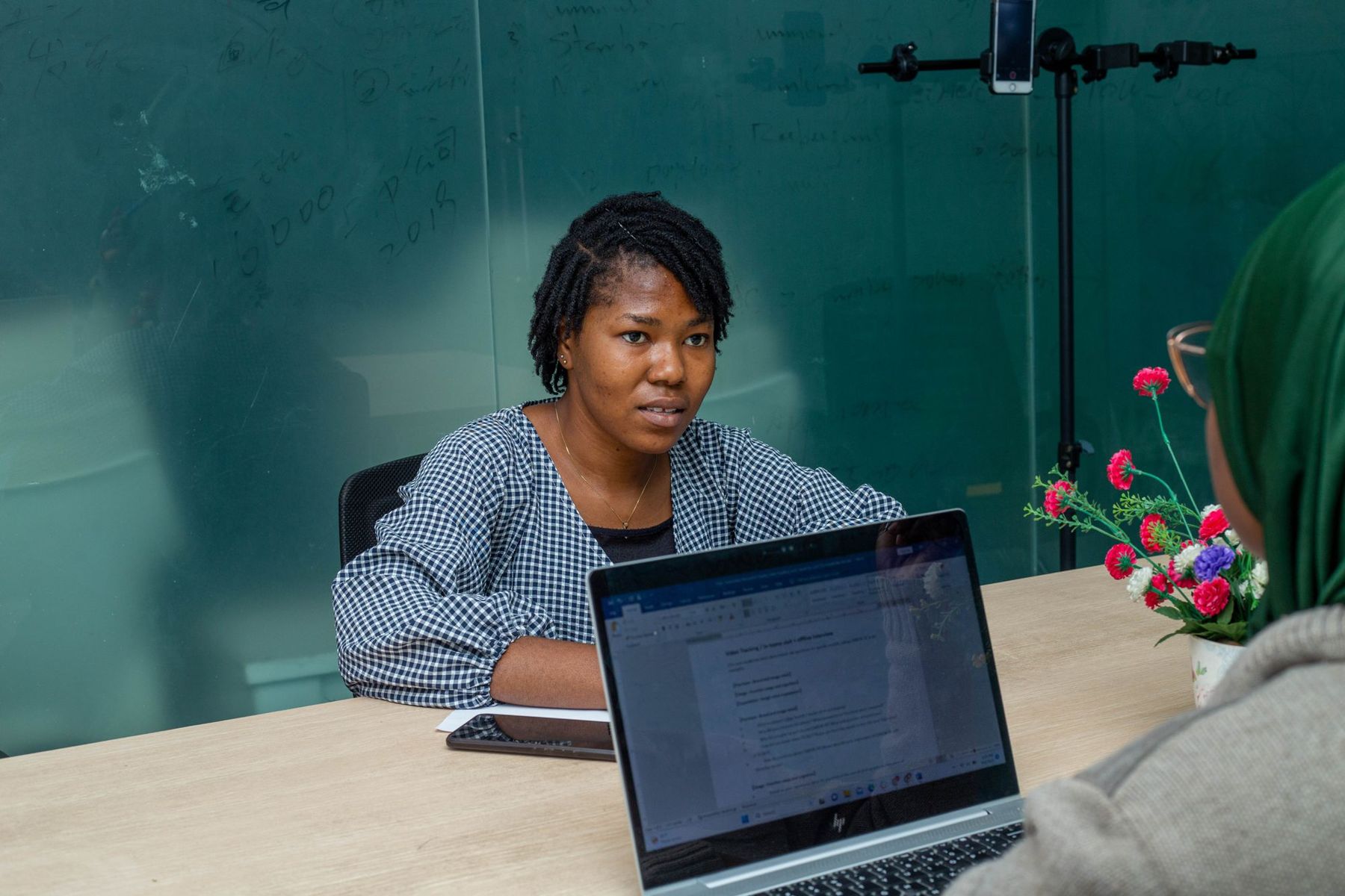 A professional working on a laptop in an office